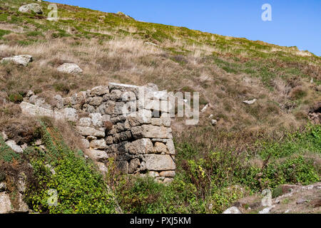 Remains of Old, Granite, Water Wheel Housing from Tin Mining at Nanjizel or Mill Bay near Lands End. Stock Photo