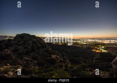 Los Angeles California predawn rocky hilltop view of the San Fernando Valley.  Burbank, North Hollywood, Griffith Park and the San Gabriel Mountains a Stock Photo