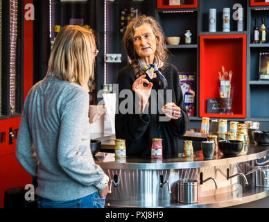 Tasting of the different varieties of mustard in the Edmont Fallot mustard fabrication in Beaune, France. Of course, there is also a sales room with all the products of Edmond Fallot and tasting is highly encouraged. Especially the fine and spicy Dijon mustard is used for salad dressings and sauces or also served with cheese Stock Photo