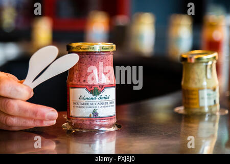 Tasting of the different types of mustard in the Edmont Fallot mustard fabrication in Beaune, France. Many of the flavored mustards still contain the mustard skins. They belong to the coarse mustards and are refined with other Burgundy specialties such as cassis, the black currant or with Pain d'Epices, gingerbread spices Stock Photo