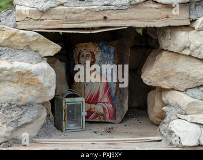 Shrine in Kato Theletra. The village was abandoned by its residents who relocated higher up the hillside after an earthquake caused landslide. Stock Photo