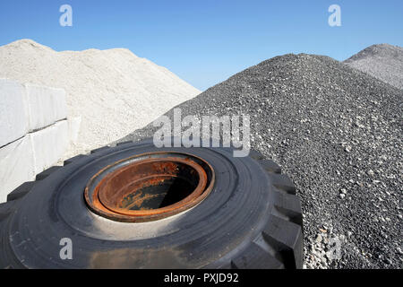 Large mound of crushed stone granite against the blue sky Stock Photo