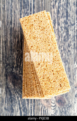 thin crispy loafs on old black table, closeup in the kitchen in the village Stock Photo