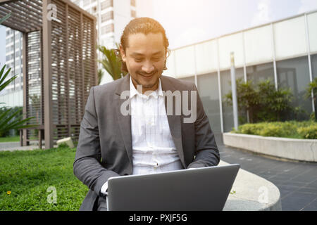 middle eastern business man using laptop outdoor Stock Photo