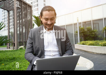middle eastern business man using laptop outdoor Stock Photo