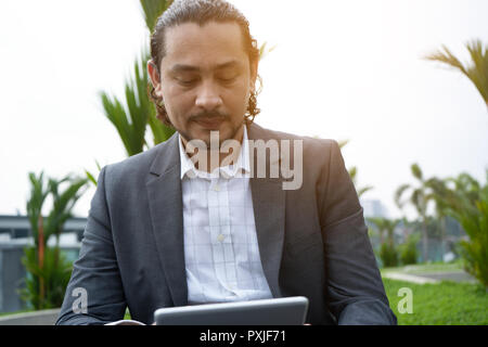 middle eastern man using tablet outdoor Stock Photo