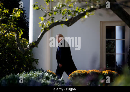 Washington, USA. 22nd Oct, 2018. U.S. President Donald Trump leaves the Oval Office at the White House in Washington, DC, the United States, on Oct. 22, 2018. Donald Trump said on Monday that his country will begin cutting off or reducing aid to three countries in Central America, citing migrant caravan heading to the U.S. border. Credit: Ting Shen/Xinhua/Alamy Live News Stock Photo