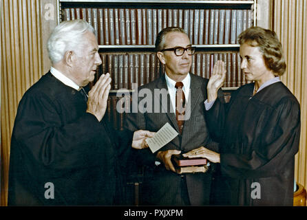 September 25, 1981 - Washington, District of Columbia, U.S. - Sandra Day O'Connor, right, is sworn-in as Associate Justice of the United States Supreme Court by Chief Justice of the United States Warren Burger, left, at the U.S. Supreme Court in Washington, D.C. on September 25, 1981.  Her husband John O'Connor, center, looks on.  Justice O'Connor is the first woman on the Supreme Court, replacing Potter Stewart..Mandatory Credit: Michael Evans / White House via CNP (Credit Image: © Michael Evans/CNP via ZUMA Wire) Stock Photo