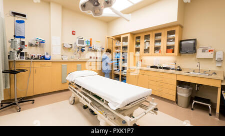 A hospital emergency room nurse stocks a cabinet with trauma supplies. Stock Photo