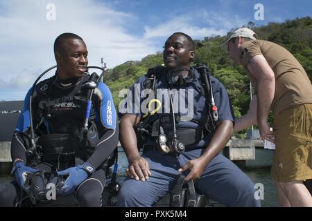 PORT OF SPAIN, Trinidad - Master Seaman Quinn Audette from Fleet Diving Unit Atlantic inspects the dive gear of divers from the Bahamas and Barbados prior to search pattern dive training in Chaguaramas, Trinidad and Tobago during Exercise TRADEWINDS 17 on June 3, 2017. (Canadian Forces Combat Camera Stock Photo