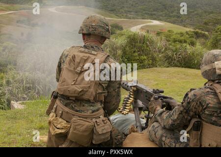 Cpl. John Glomba, left, and Pfc. Luis Steponovich, both  with Weapons Company, Battalion Landing Team, 3rd Battalion, 5th Marines, 31st Marine Expeditionary Unit, fire a .50-caliber Browning machine gun during training at Camp Schwab, Okinawa, Japan, June 1, 2017. Glomba is a dismount squad leader and Steponovich is a machine gunner. The M2, sometimes called the “Ma Deuce,” is the oldest machine gun currently in the Marine Corps’ arsenal.  BLT 3/5 is currently deployed as the Ground Combat Element of the 31st Marine Expeditionary Unit. Weapons Company is the heavy-weapons elements of BLT 3/5.  Stock Photo