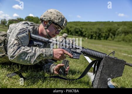 U.S. Army Spc. Bryant Pinette, with Delta Company, 2nd Battalion, 108th Infantry Regiment, New York Army National Guard, loads his M4 carbine during the SGT Henry Johnson Individual Combat Rifle Match as part of the 38th Annual The Adjutant General's Combat Sustainment Training Exercise (TAG Match) at Camp Smith Training Site, N.Y., June 3, 2017. The TAG Match is a 3-day event conducted by the New York Army National Guard to promote excellence in marksmanship training and offer Soldiers, Airmen and State Militia the opportunity to test their marksmanship skills and weapon systems in a battle-f Stock Photo