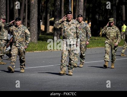 Maj. Gen. Leonids Kalnins(center), chief of defense for the Republic of Latvia, takes his post for the opening ceremony of Exercise Saber Strike 17 aboard Adazi Military Base, Latvia, June 3, 2017. Saber Strike is a multinational training evolution to increase interoperability and strengthen relationships with NATO Allies and partner nations through combined-arms training. Stock Photo