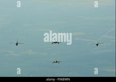 F-16 Fighting Falcons assigned to the 180th Fighter Wing, Ohio Air National Guard, fly in formation alongside two Hungarian JAS 39 Grippens over the skies of Hungary during exercise Load Diffuser 17 at Kecskemet Air Base, Hungary, June 6, 2017. More than 150 Airmen from the 180FW and eight F-16s are participating in the Hungarian led, two week multinational exercise focused on enhancing interoperability capabilities and skills among NATO allied and European partner air forces by conducting joint operations and air defenses to maintain joint readiness, while also bolstering relationships within Stock Photo