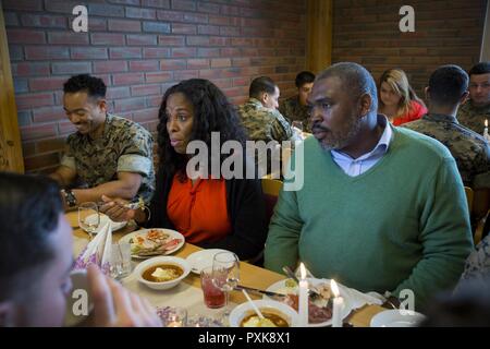 U.S. Representative Stacey Plaskett of the Virgin Islands and her husband, Jonathan Buckney-Small, eat a meal with Marines of Marine Rotational Force Europe 17.1 (MRF-E) at Vaernes Garnison, Norway, June 2, 2017. Marines and representatives discussed what life is like deployed in Norway. MRF-E preserves the U.S.’s commitment to Norway and its mutual trust as they confront evolving strategic challenges together. Stock Photo
