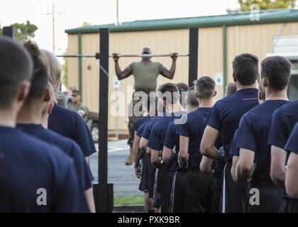 A U.S. Marine demonstrates how to conduct pull-ups for future Marines during a shipper’s validation in Smyrna, Tennessee, June 2, 2017. The shipper’s validation ensures future Marines in the Marine Corps Delayed Entry Program are ready for the rigors of Marine Corps recruit training. Stock Photo