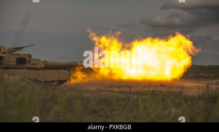 ADAZI, Latvia – Marines with Alpha Company, 4th Tank Battalion, 4th Marine Division, Marine Forces Reserve, fire from a M1 Abrams tank during Exercise Saber Strike 17 in the Adazi Training Area, Latvia, June 4, 2017. Exercise Saber Strike 17 is an annual combined-joint exercise conducted at various locations throughout the Baltic region and Poland. The combined training exercise keeps Reserve Marines ready to respond in times of crisis by providing them with unique training opportunities outside of the continental United States. Stock Photo