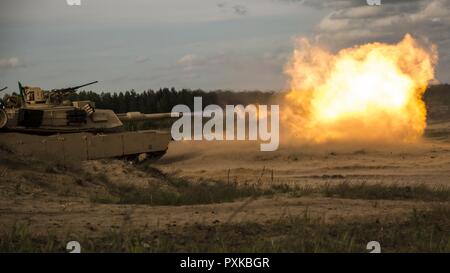 ADAZI, Latvia – Marines with Alpha Company, 4th Tank Battalion, 4th Marine Division, Marine Forces Reserve, fire from a M1 Abrams tank during Exercise Saber Strike 17 in the Adazi Training Area, Latvia, June 4, 2017. Exercise Saber Strike 17 is an annual combined-joint exercise conducted at various locations throughout the Baltic region and Poland. The combined training exercise keeps Reserve Marines ready to respond in times of crisis by providing them with unique training opportunities outside of the continental United States. Stock Photo