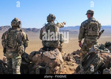 Members of the 238th Air Support Operations Squadron, Mississippi Air National Guard, observe the live fire training area before calling in close air support June 6, 2017 at the National Training Center. (Mississippi Stock Photo