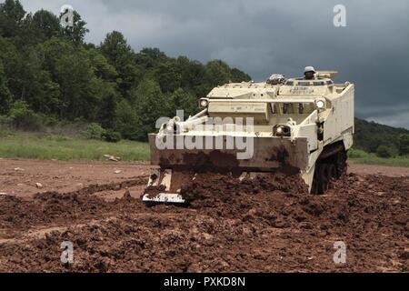 Sgt. Ricardo Lindsay, horizontal construction engineer with 252nd Quarter Master Company, 728th Combat Sustainment Support Battalion, 213th Regional Support Group, Pennsylvania Army National Guard, operates an M9 armored combat earthmover during annual training at Fort Indiantown Gap June 7, 2017. Stock Photo