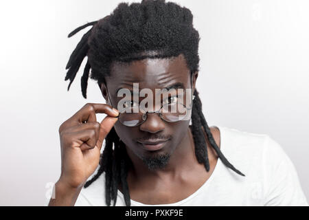 Afro American man with dreadlocks and glasses is looking at camera Stock Photo