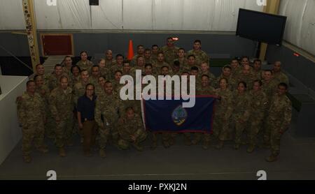 Service members pose for a group photo on Bagram Airfield, Afghanistan, June 7, 2017. Service members from Guam, which has the most military personnel per capita, have a large footprint in Afghanistan. Despite being only 210 square miles large and a having population of only 160,000, multiple service members and civilians from the Department of Defense and other government agencies currently serve in the region. Stock Photo