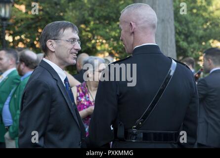 Secretary of the Navy the Honorable Sean J. Stackley, left, speaks to U.S. Marine Corps Col. Tyler J. Zagurski, commanding officer, Marine Barracks Washington, before an evening parade at Marine Barracks Washington, Washington, D.C., June 9, 2017. Evening parades are held as a means of honoring senior officials, distinguished citizens and supporters of the Marine Corps. Stock Photo