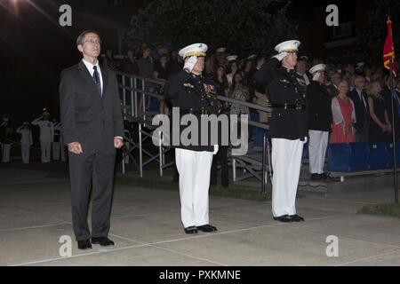 From left, Secretary of the Navy the Honorable Sean J. Stackley, Commandant of the Marine Corps Gen. Robert B. Neller and U.S. Marine Corps Col. Tyler J. Zagurski, commanding officer, Marine Barracks Washington, render honors during an evening parade at Marine Barracks Washington, Washington, D.C., June 9, 2017. Evening parades are held as a means of honoring senior officials, distinguished citizens and supporters of the Marine Corps. Stock Photo