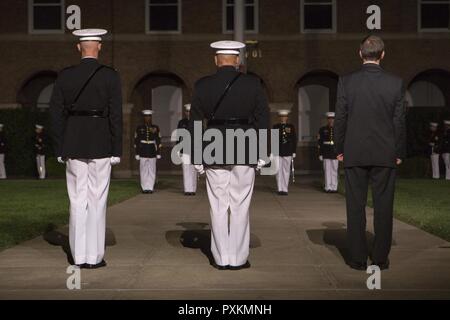 From right, Secretary of the Navy the Honorable Sean J. Stackley, Commandant of the Marine Corps Gen. Robert B. Neller and U.S. Marine Corps Col. Tyler J. Zagurski, commanding officer, Marine Barracks Washington, render honors during an evening parade at Marine Barracks Washington, Washington, D.C., June 9, 2017. Evening parades are held as a means of honoring senior officials, distinguished citizens and supporters of the Marine Corps. Stock Photo