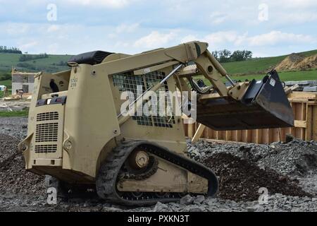 Soldiers from the 465th Company, 926th Engineer Battalion, 926th Engineer Brigade, United States Army Reserves, use a Skid Steer to introduce leveling dirt for the approach lane at an ammunition-loading dock at the Joint National Training Center, Cincu, Romania, as part of Resolute Castle 2017. Resolute Castle is an exercise strengthening the NATO alliance and enhancing its capacity for joint training and response to threats within the region. Stock Photo