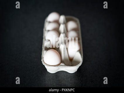 Eggs in an egg box, one missing Stock Photo