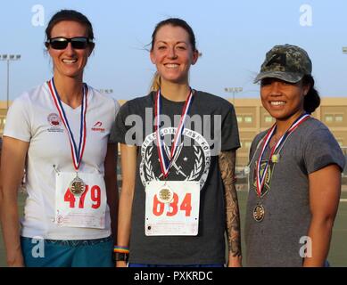 U.S. Army Maj. Ashley Hall (left), 86th Combat Support Hospital,  U.S. Army 1st Lt. Azelia Adams , Combined Joint Task Force-Operation Inherent Resolve, and U.S. Army 1st Lt. Katrina Donarski, 4th Battalion, 5th Air Defense Artillery Regiment, finished as the top three females in the Army’s 242nd Birthday 5K run race, at Camp Arifjan, Kuwait, June 14, 2017. This year’s birthday commemorates the World War I Soldiers who helped the American Army become the world’s most adaptive and competent land force in history. Stock Photo