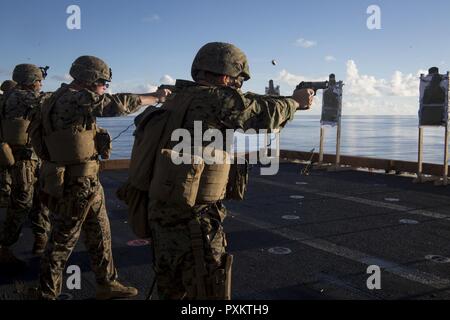 Marines with Combat Logistics Battalion 31 fire M1911 .45-caliber pistols during marksmanship training aboard the USS Bonhomme Richard (LHD 6), June 15, 2017. CLB-31 is permanently assigned to the 31st MEU and provides support for all elements of the MEU. The 31st MEU partners with the Navy’s Amphibious Squadron 11 to form the amphibious component of the Bonhomme Richard Expeditionary Strike Group. The 31st MEU and PHIBRON 11 combine to provide a cohesive blue-green team capable of accomplishing a variety of missions across the Indo-Asia-Pacific region. Stock Photo