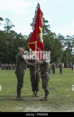 U.S. Marine Corps Lt. Col. Todd B. Sanders, right, passes the Marine Corps flag to Lt. Col. Sean P. Mullen during the Combat Logistics Battalion 22 change of command ceremony at Soifert Field on Camp Lejeune, N.C., June 16, 2017. During the ceremony, Sanders relinquished command to Mullen. Stock Photo