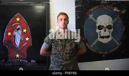 Cpl. Blake Cannon stands proudly in front of B Battery unit logos at Marine Corps Air Station Cherry Point, N.C., June 9, 2017. Cannon is a team leader assigned to 1st platoon of B Battery, 2nd Low Altitude Air Defense Battallion, Marine Air Control Group 28, and takes on the responsibilty of training the Marines in his team to the highest standards. Stock Photo