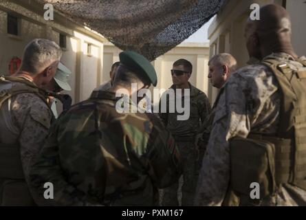 A U.S. Army infantry officer, center/right, with Task Force Iron, show key leaders around the artillery position at Bost Airfield, Afghanistan, June 10, 2017. The Soldiers are here to provide accurate fires capabilities in support of Task Force Southwest and Afghan National Defense and Security Forces during current operations. Task Force Southwest, comprised of approximately 300 Marines and Sailors from II Marine Expeditionary Force, are training, advising and assisting the Afghan National Army 215th Corps and the 505th Zone National Police. Stock Photo