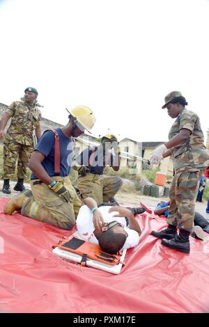 Rescue team members work at the site of a plane fire at Muan ...