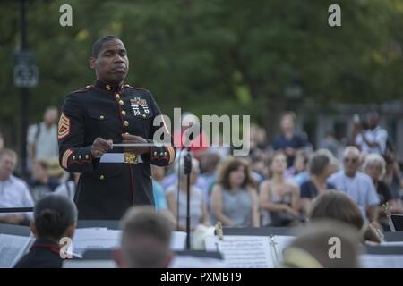 NEW YORK – Gunnery Sgt. Justin A. Hauser, enlisted conductor of Marine Corps Band New Orleans, conducts the Marine Corps Band New Orleans at Washington Square Park in New York, June 14, 2017. The Band’s performance at Washington Square Park was the first of three concerts held throughout New York City, June 14-16. Stock Photo