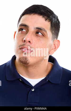 Face of young Hispanic man thinking while looking up  Stock Photo