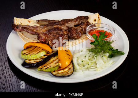 Delicious fried lamb loin with pita and roasted pepper Stock Photo - Alamy