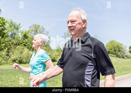 Senior couple running in park Stock Photo