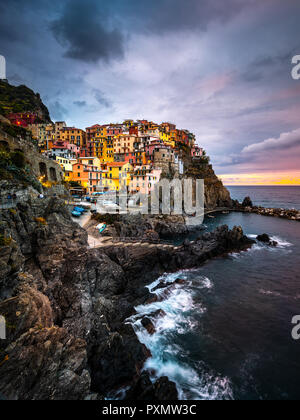 Manarola Village, Cinque Terre Coast of Italy. Manarola a beautiful small town in the province of La Spezia, Liguria, north of Italy and one of the five Cinque terre travel attractions, Sunset colors Stock Photo