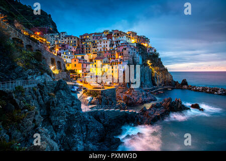 Manarola Village, Cinque Terre Coast of Italy. Manarola a beautiful small town in the province of La Spezia, Liguria, north of Italy and one of the five Cinque terre travel attractions, Sunset colors Stock Photo