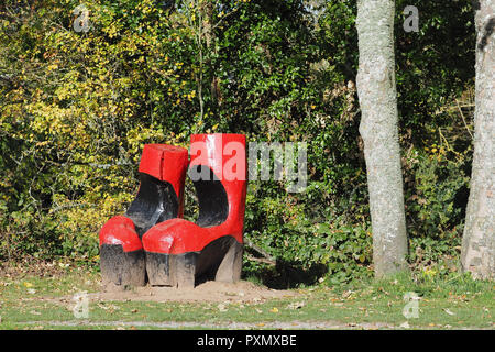 Wood carving called Foot in both camps at Inch field beside Cahir castle, County Tipperary, Ireland Stock Photo