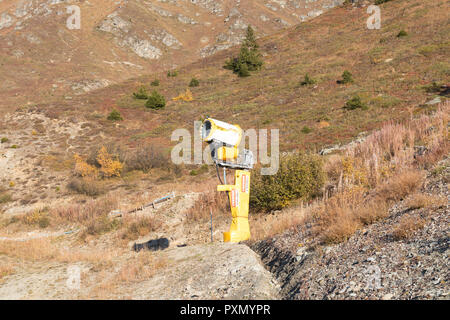 Snow gun machine waiting for frost with sun flare background, snowmaker  machine. Color effect Stock Photo - Alamy