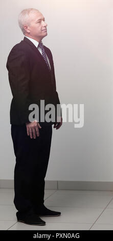 side view. senior businessman is putting his hands in his pockets. Stock Photo