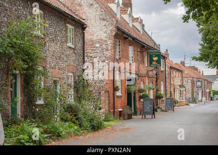 The picturesque village of Castle Acre Norfolk, looking towards Stocks Green, the Ostrich pub and the Albert Victor Inn. England, UK Stock Photo