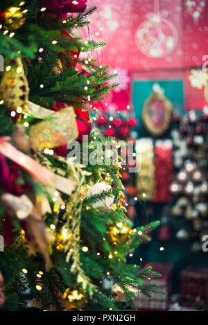 Decorated Christmas tree on blurred, sparkling and fairy background Stock Photo