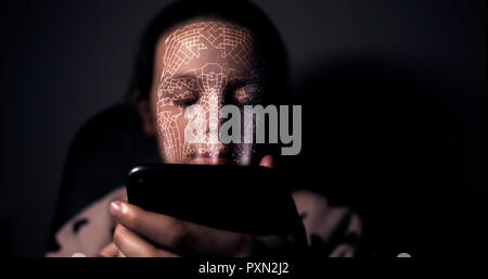Young girl holding her smart phone and using facial recognition to unlock the device Stock Photo