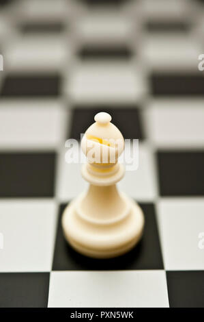 white chess piece Bishop on the chessboard Stock Photo